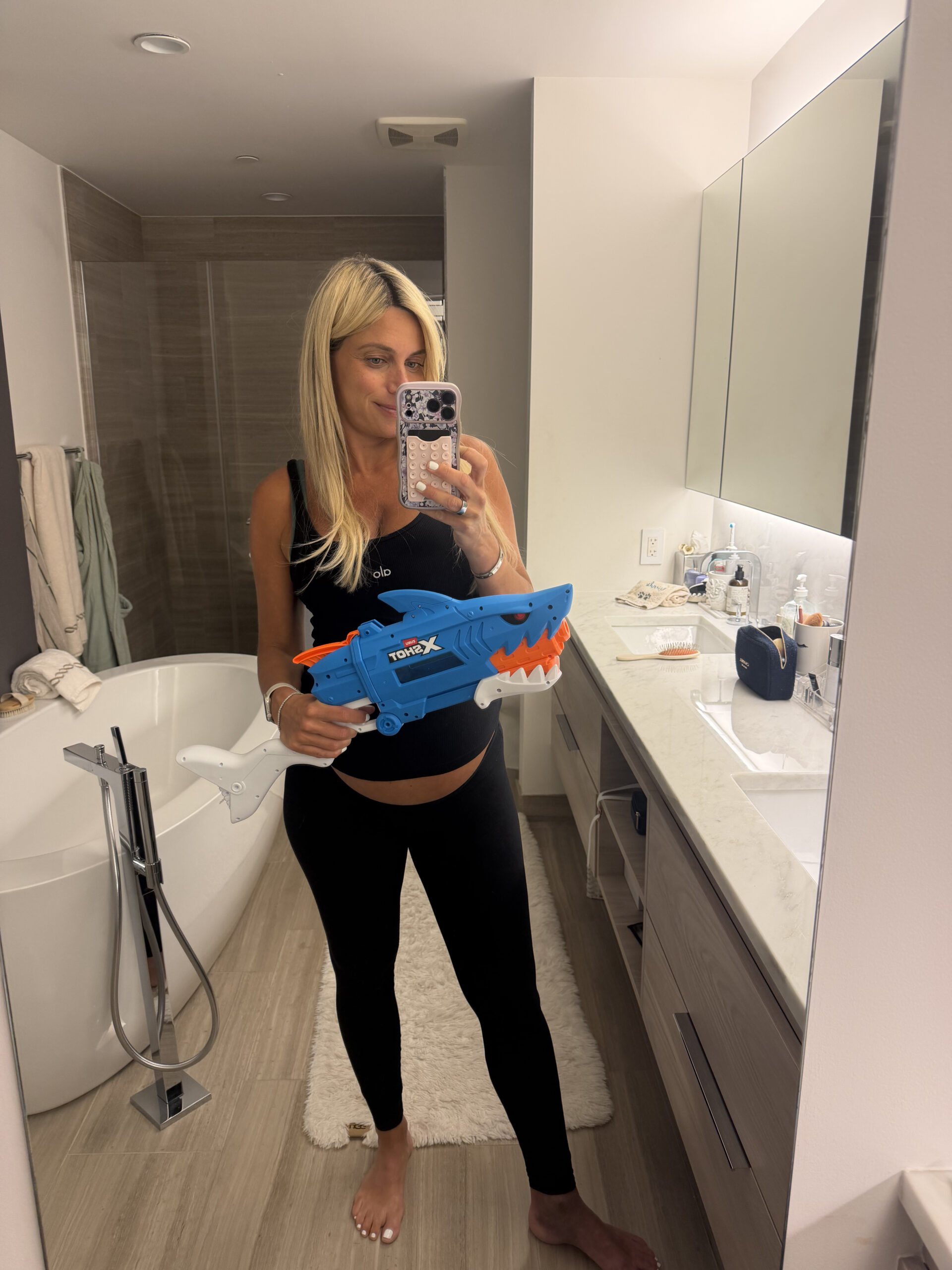 JoAnna holding her toddler’s water gun